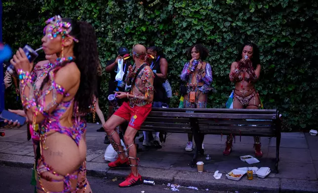Revellers gather ahead of the Notting Hill Carnival in London, Monday, Aug. 31, 2026. (AP Photo/Ohad Zwigenberg)