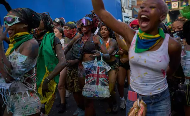 Revellers attend the J'Ouvert, the opening event of the Notting Hill Carnival, in London, Sunday, Aug. 30, 2026. (AP Photo/Ohad Zwigenberg)