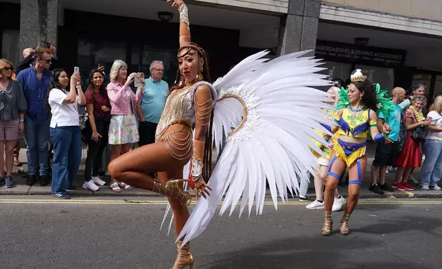 A reveller celebrates during the Notting Hill Carnival parade in London, Monday, Aug. 31, 2026, Europe's biggest street party and one of the largest carnivals in the world. (AP Photo/Alberto Pezzali)