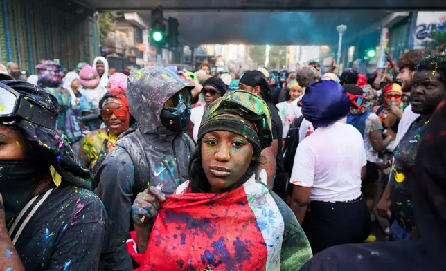Revellers attend the J'Ouvert, the opening event of the Notting Hill Carnival, in London, Sunday, Aug. 30, 2026. (AP Photo/Alberto Pezzali)