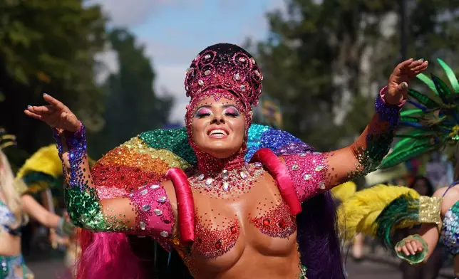 A reveller celebrates during the Notting Hill Carnival parade in London, Monday, Aug. 31, 2026, Europe's biggest street party and one of the largest carnivals in the world. (AP Photo/Alberto Pezzali)