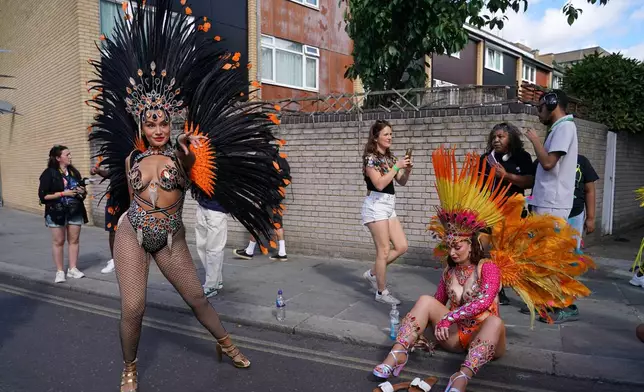 Revellers prepare for the Notting Hill Carnival parade in London, Monday, Aug. 31, 2026, Europe's biggest street party and one of the largest carnivals in the world. (AP Photo/Alberto Pezzali)