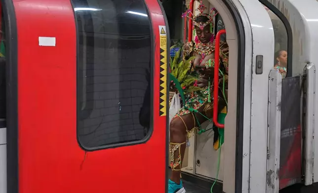 A dressed up reveller arrives on the tube to celebrate Notting Hill Carnival in London, Monday, Aug. 31, 2026, Europe's biggest street party and one of the largest carnivals in the world. (AP Photo/Alberto Pezzali)