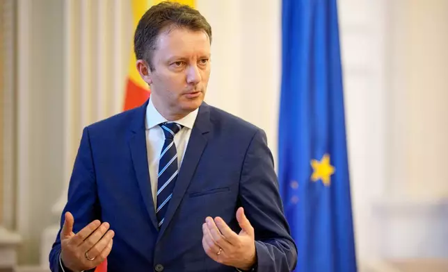 Romanian Prime Minister designate Siegfried Muresan gestures after an interview with the Associated Press at the Palace of Parliament in Bucharest, Romania, Monday, Sept. 28, 2026. (AP Photo/Andreea Alexandru)