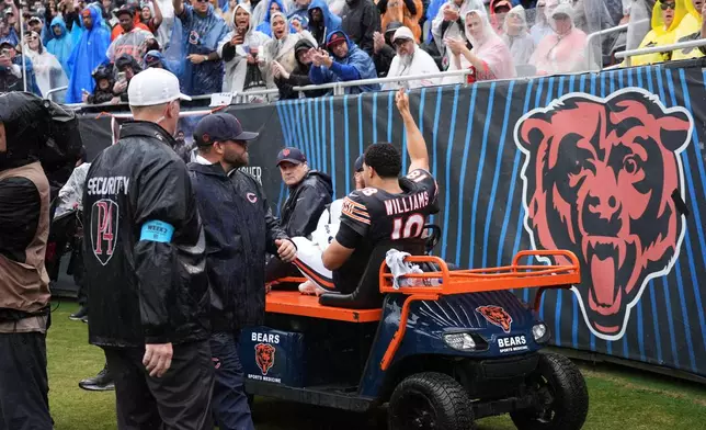 Chicago Bears quarterback Caleb Williams (18) waves as he is carted off the field after an injury during the second half of an NFL football game against the Minnesota Vikings in Chicago, Sunday, Sept. 20, 2026. (AP Photo/Nam Y. Huh)