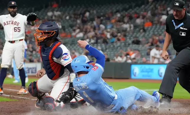 Kansas City Royals' Isaac Collins (1) scores as Houston Astros catcher Yainer Diaz reaches to tag him during the eighth inning of a baseball game Wednesday, Sept. 16, 2026, in Houston. (AP Photo/David J. Phillip)
