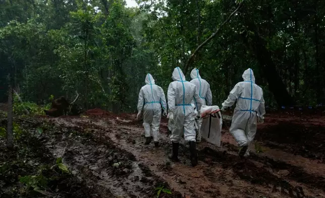 Nepal's paramilitary force personnel carry the body of a flash flood victim for burial at a mass burial site in Chitwan, Nepal, Monday, Aug. 31, 2026. (AP Photo/Dar Yasin)