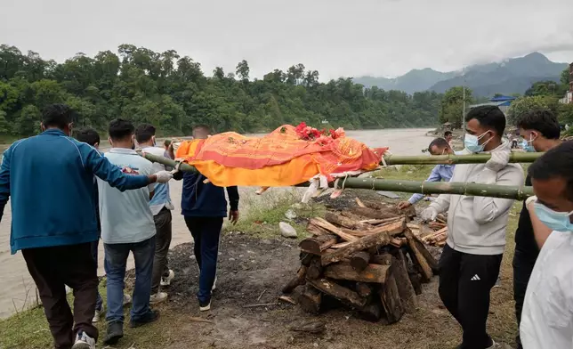 Relatives and friends cremate Aayush Khada who was killed in flash floods, in Chitwan, Nepal, Monday, Aug. 31, 2026. (AP Photo/Dar Yasin)