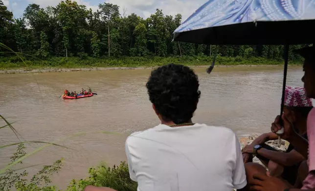Nepalese army soldiers look for bodies of flash flood victims amid a rescue operation from a river in Chitwan, Nepal, Monday, Aug. 31, 2026. (AP Photo/Dar Yasin)