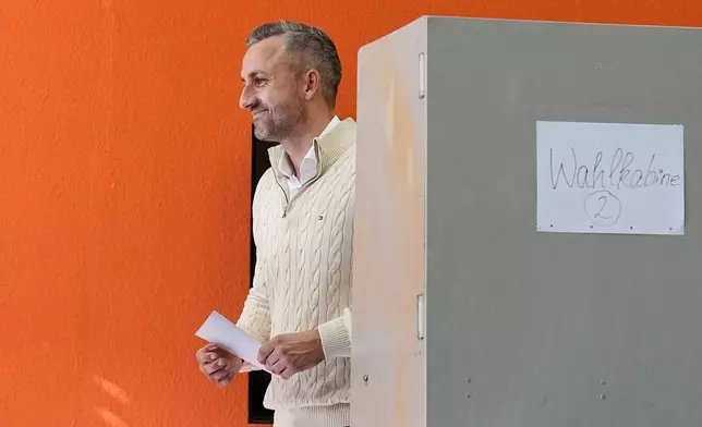 Ulrich Siegmund, top candidate for the "Alternative for Germany" (AfD) party votes at a polling station during the Saxony-Anhalt state elections in Tangermuende, eastern Germany, Sunday, Sept. 6, 2026. (AP Photo/Matthias Schrader)