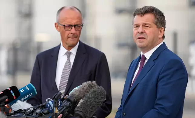 German Chancellor and Christian Democratic Union (CDU) party leader Friedrich Merz, left, and Saxony-Anhalt State Governor and top candidate Sven Schulze give a press statement after visiting UPM Biochemicals in Leuna, Germany, Thursday, Sept. 3, 2026. (AP Photo/Matthias Schrader)