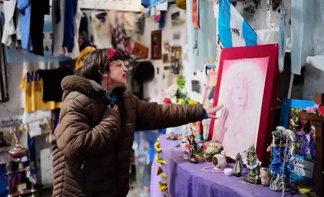 A person prays at a sanctuary dedicated to late Argentine singer Gilda on the 30th anniversary of her death in a bus crash, in Entre Rios, Argentina, Monday, Sept. 7, 2026. (AP Photo/Natacha Pisarenko)