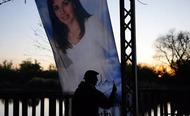 A man takes a picture at a sanctuary dedicated to Argentine singer Gilda on the 30th anniversary of her death in a bus crash, in Entre Rios, Argentina, Monday, Sept. 7, 2026. (AP Photo/Natacha Pisarenko)