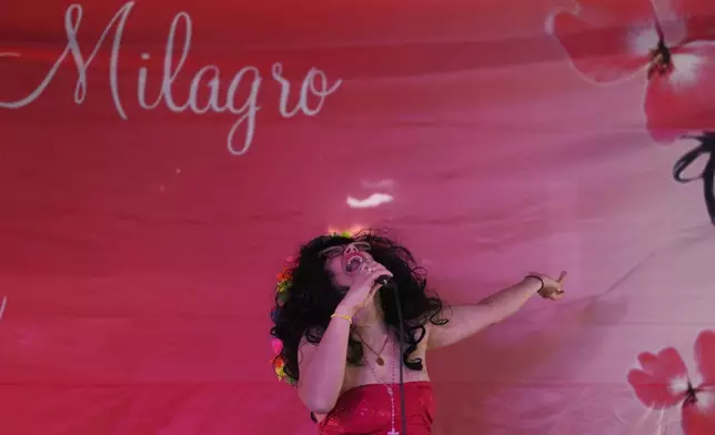 A woman sings at a sanctuary dedicated to late Argentine singer Gilda on the 30th anniversary of her death in a bus crash, in Entre Rios, Argentina, Monday, Sept. 7, 2026. (AP Photo/Natacha Pisarenko)
