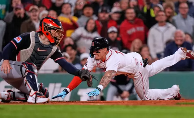 Boston Red Sox's Jarren Duran, right, beats the throw to Cleveland Guardians' Patrick Bailey to score on a single by Andruw Monasterio during the sixth inning of a baseball, Wednesday, Sept. 23, 2026, in Boston. (AP Photo/Charles Krupa)