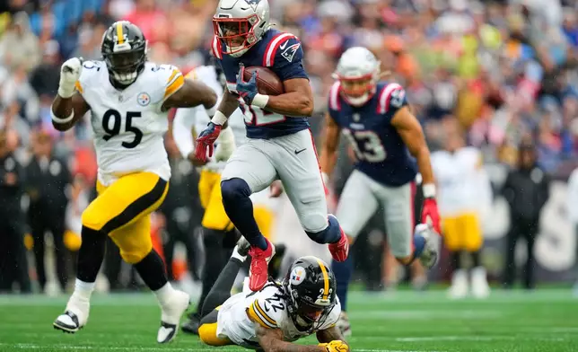 New England Patriots' Treveyon Henderson (32) leaps over Pittsburgh Steelers' Asante Samuel Jr. (22) on his way to a touchdown during the first half of an NFL football game, Sunday, Sept. 20, 2026, in Foxboro, Mass. (AP Photo/Charles Krupa)