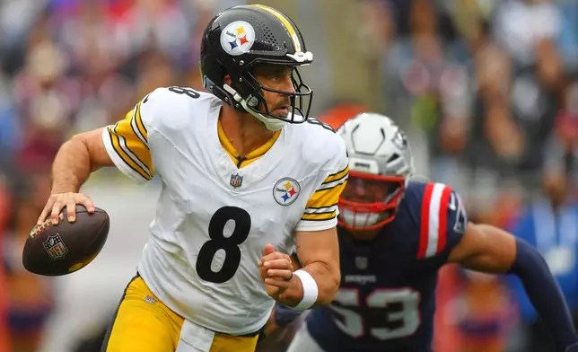 Pittsburgh Steelers' Aaron Rodgers (8) looks to pass as New England Patriots' Christian Elliss (53) pressures him during the first half of an NFL football game, Sunday, Sept. 20, 2026, in Foxboro, Mass. (AP Photo/Steven Senne)