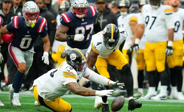 Pittsburgh Steelers' Troy Fautanu (76) and DK Metcalf (4) recover the ball after quarterback Aaron Rodgers was sacked during the first half of an NFL football game against the New England Patriots, Sunday, Sept. 20, 2026, in Foxboro, Mass. (AP Photo/Charles Krupa)