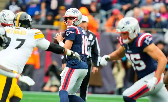 New England Patriots' Drake Maye (10) looks to pass during the first half of an NFL football game against the Pittsburgh Steelers, Sunday, Sept. 20, 2026, in Foxboro, Mass. (AP Photo/Charles Krupa)
