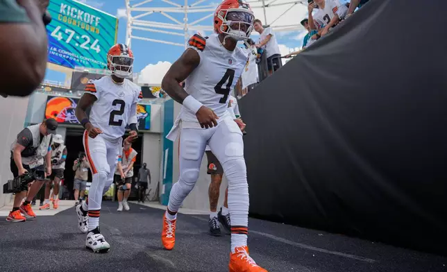 Cleveland Browns quarterback Deshaun Watson (4) and quarterback Shedeur Sanders (2) run onto the field before an NFL football game against the Jacksonville Jaguars, Sunday, Sept. 13, 2026, in Jacksonville. (AP Photo/Mike Stewart)