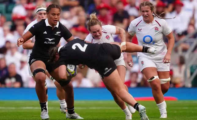 New Zealand's Georgia Ponsonby is tackled by England's Megan Jones during the WXV Global Series match between England and New Zealand in London, Saturday Sept. 26, 2026. (David Davies/PA via AP)