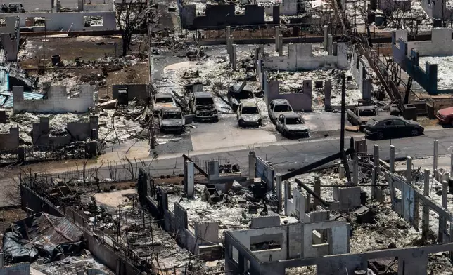 FILE - Charred vehicles remain near burned homes in the aftermath of a wildfire in Lahaina, Hawaii, Aug. 22, 2023. (AP Photo/Jae C. Hong, File)