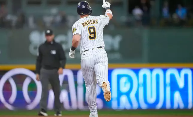 Milwaukee Brewers' Jake Bauers reacts after hitting a home run during the seventh inning of a baseball game against the Cincinnati Reds, Sunday, Sept. 13, 2026, in Milwaukee. (AP Photo/Kayla Wolf)
