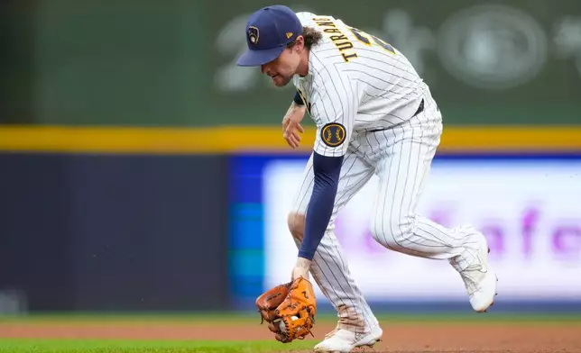 Milwaukee Brewers second baseman Brice Turang fields a groundout hit by Cincinnati Reds' Jose Trevino during the fifth inning of a baseball game Sunday, Sept. 13, 2026, in Milwaukee. (AP Photo/Kayla Wolf)