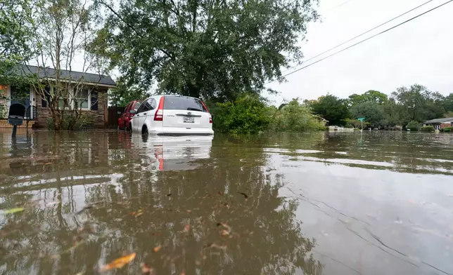FILE - A car sits in floodwaters from Hurricane Ian, Sept. 30, 2022, in Charleston, S.C. (AP Photo/Alex Brandon, File)