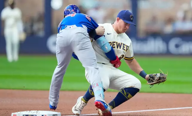 Chicago Cubs' Pete Crow-Armstrong, left, runs into Milwaukee Brewers first baseman Andrew Vaughn, right, after grounding out during the first inning of a baseball game Monday, Sept. 7, 2026, in Milwaukee. (AP Photo/Kayla Wolf)