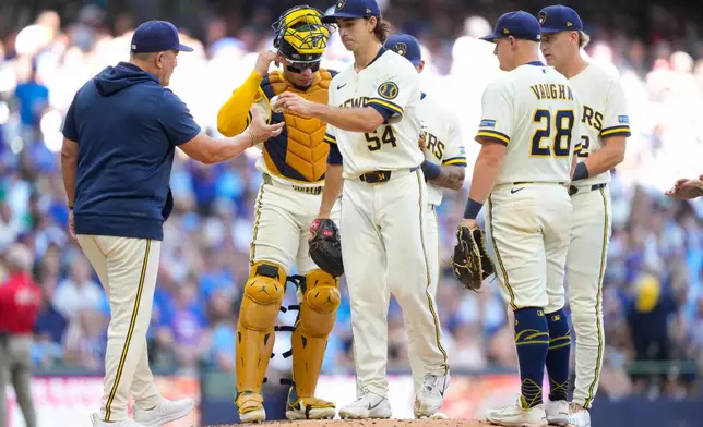 Milwaukee Brewers pitcher Robert Gasser (54) hands the ball to manager Pat Murphy, left, for a pitching change during the fifth inning of a baseball game against Chicago Cubs Monday, Sept. 7, 2026, in Milwaukee. (AP Photo/Kayla Wolf)