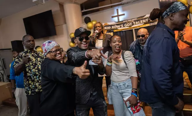 Winners, judges and volunteers celebrate after the winners are announced at the end of Skid Row's inaugural talent show in downtown Los Angeles, Saturday, Sept. 19, 2026. (AP Photo/Jae C. Hong)
