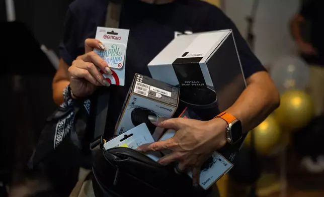 Bok Seo, a volunteer from a local Korean church, holds prizes for contestants during Skid Row's inaugural talent show in downtown Los Angeles, Saturday, Sept. 19, 2026. (AP Photo/Jae C. Hong)