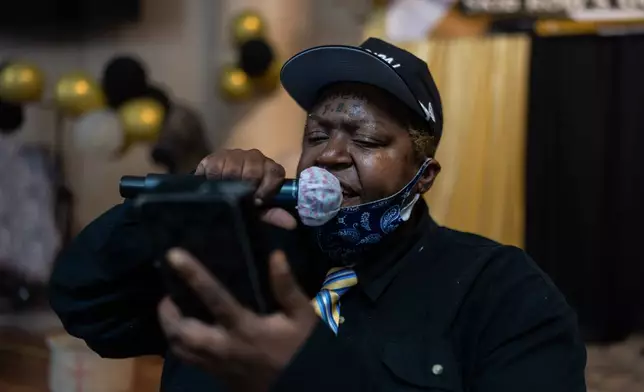 Trianice, a contestant who provided only her first name, reads a poem during Skid Row's inaugural talent show in downtown Los Angeles, Saturday, Sept. 19, 2026. (AP Photo/Jae C. Hong)