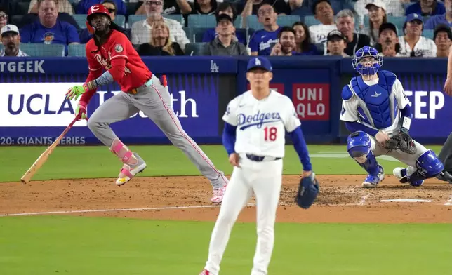Cincinnati Reds' Elly De La Cruz, left, heads to first for a solo home run as Los Angeles Dodgers pitcher Yoshinobu Yamamoto, center, watches along with catcher Will Smith during the fourth inning of a baseball game Wednesday, Sept. 9, 2026, in Los Angeles. (AP Photo/Mark J. Terrill)