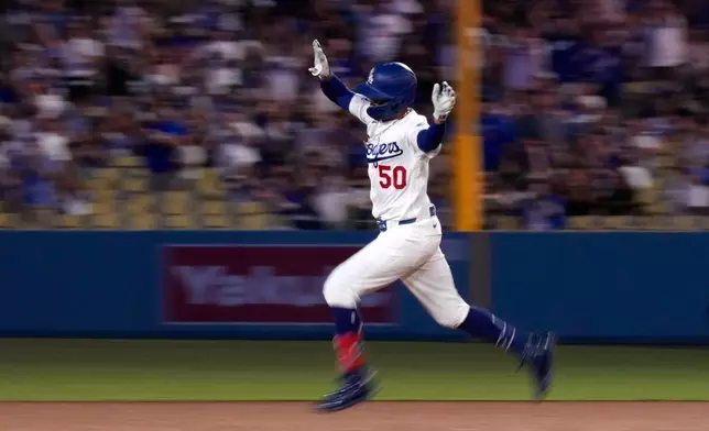 Los Angeles Dodgers' Mookie Betts celebrates after hitting a two-run home run during the third inning of a baseball game against the Cincinnati Reds, Wednesday, Sept. 9, 2026, in Los Angeles. (AP Photo/Mark J. Terrill)