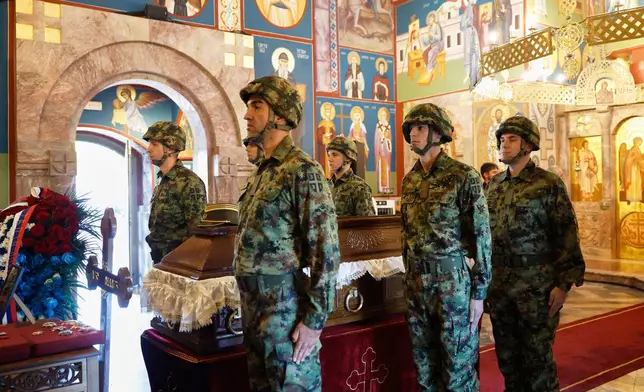 Serbian national military servicemen stand around the coffin of the former Bosnian Serb army commander Ratko Mladic, who died last week while serving a life sentence for genocide and other atrocities during the war in Bosnia, at the St. Luka Church, in Belgrade, Serbia, Monday, Sept. 7, 2026. (AP Photo/Marko Drobnjakovic)