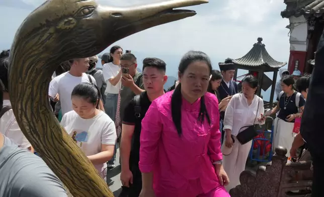Visitors line up to pray at the Golden Hall in Wudang Mountains in central China's Hubei Province on Sept. 3, 2026. (AP Photo/Achmad Ibrahim)