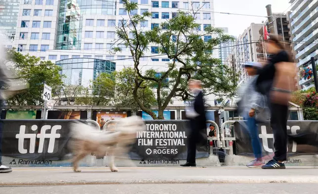 People walk past the signage for the Toronto International Film Festival in Toronto, on Thursday, Sept. 10, 2026. (Keito Newman/The Canadian Press via AP)