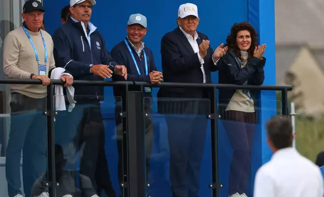U.S. President Donald Trump applauds to golfer Rory McIlroy of Northern Ireland during the Irish Open at the Trump International Golf Links course in Doonbeg, Ireland, Saturday, Sept. 12, 2026.(AP Photo/Peter Morrison)