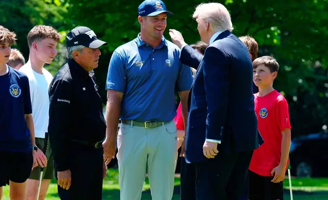 FILE - Golfers Bryson DeChambeau, center, and Gary Player, left, speak with President Donald Trump as children observe on the south lawn of the White House, May 5, 2026, in Washington. (AP Photo/Jacquelyn Martin, File)
