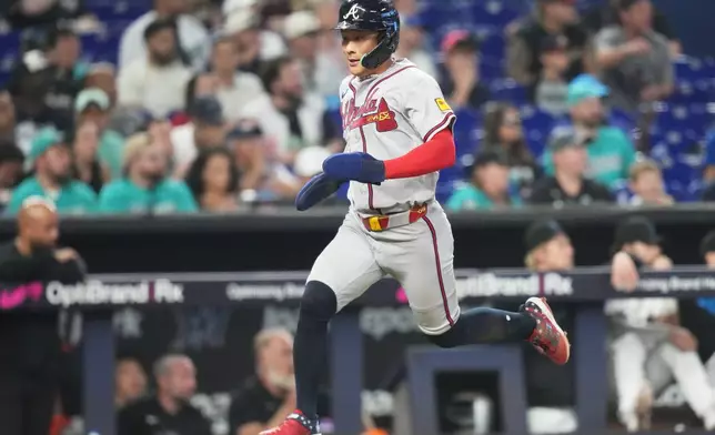 Atlanta Braves' Ha-Seong Kim runs to score on a fielder's choice by Ronald Acuña Jr. during the third inning of a baseball game against the Miami Marlins, Saturday, Sept. 26, 2026, in Miami. (AP Photo/Lynne Sladky)