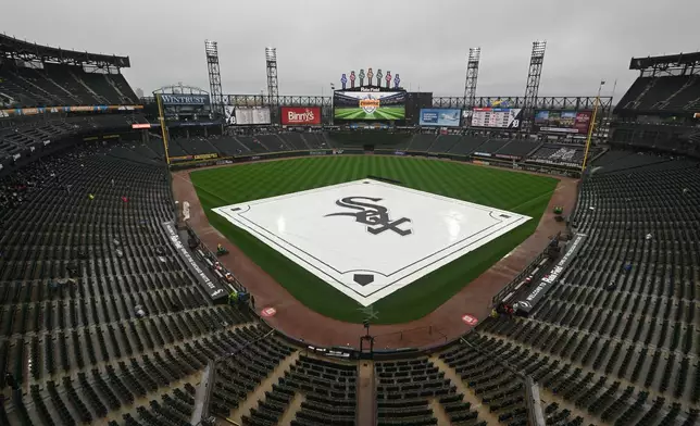 A tarp covers the field during a rain delay before a baseball game between the Chicago White Sox and the Detroit Tigers, Sunday, Sept. 20, 2026, in Chicago. (AP Photo/Paul Beaty)