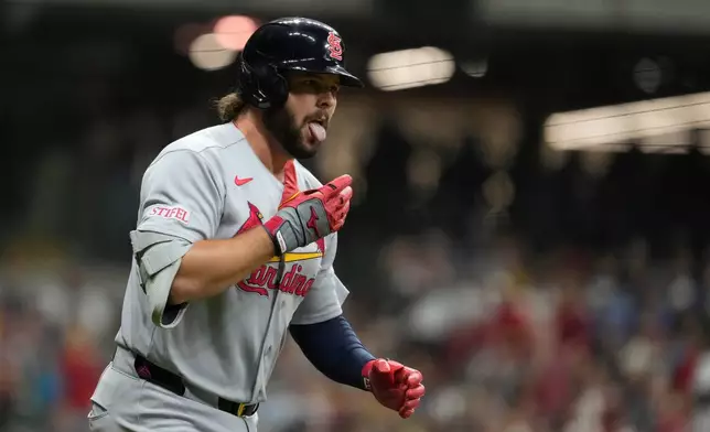 St. Louis Cardinals' Alec Burleson gestures as he rounds the bases after hitting a two-run home run during the seventh inning of a baseball game against the Milwaukee Brewers, Friday, Sept. 25, 2026, in Milwaukee. (AP Photo/Aaron Gash)