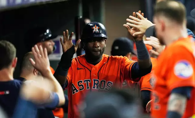 Houston Astros designated hitter Yordan Alvarez (44) celebrates in the dugout after scoring during the fourth inning of a baseball game against the Atlanta Braves in Houston, Friday, Sept. 18, 2026. (AP Photo/Ashley Landis)