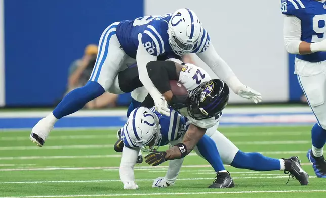Baltimore Ravens' Derrick Henry is stopped by Indianapolis Colts' DeForest Buckner and A.J. Haulcy during the second half of an NFL football game Sunday, Sept. 13, 2026, in Indianapolis. (AP Photo/AJ Mast)