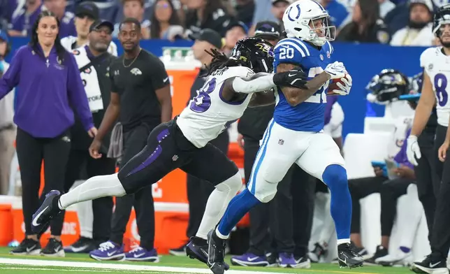 Indianapolis Colts' Seth McGowan is stopped by Baltimore Ravens' Carl Jones after a long kick off return during the second half of an NFL football game Sunday, Sept. 13, 2026, in Indianapolis. (AP Photo/AJ Mast)