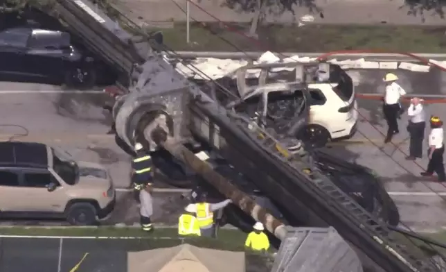 This image taken from a WSVN video shows Miami authorities responding to the scene of a crane that collapsed at a Miami construction site Monday, Sept. 14, 2026. (WSVN via AP)