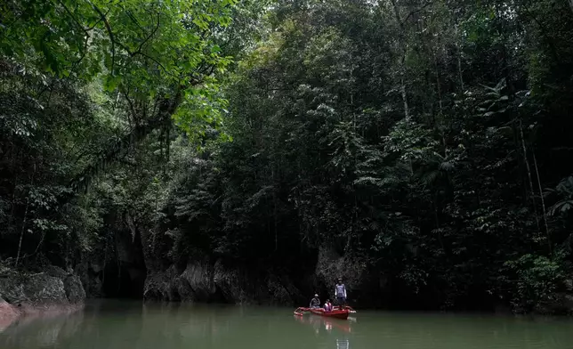 FILE - Men on a boat maneuver near the Bokimaruru Cave in Central Halmahera, North Maluku, Indonesia, June 7, 2024. (AP Photo/Achmad Ibrahim, File)