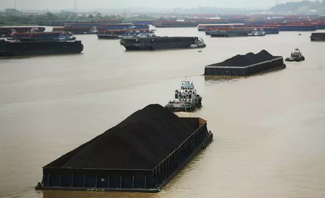 Tug boats pull barges loaded with coal on Mahakam River in Samarinda, East Kalimantan, Indonesia, on Aug. 19, 2026. (AP Photo/Ahmad Mulia Panjaitan)